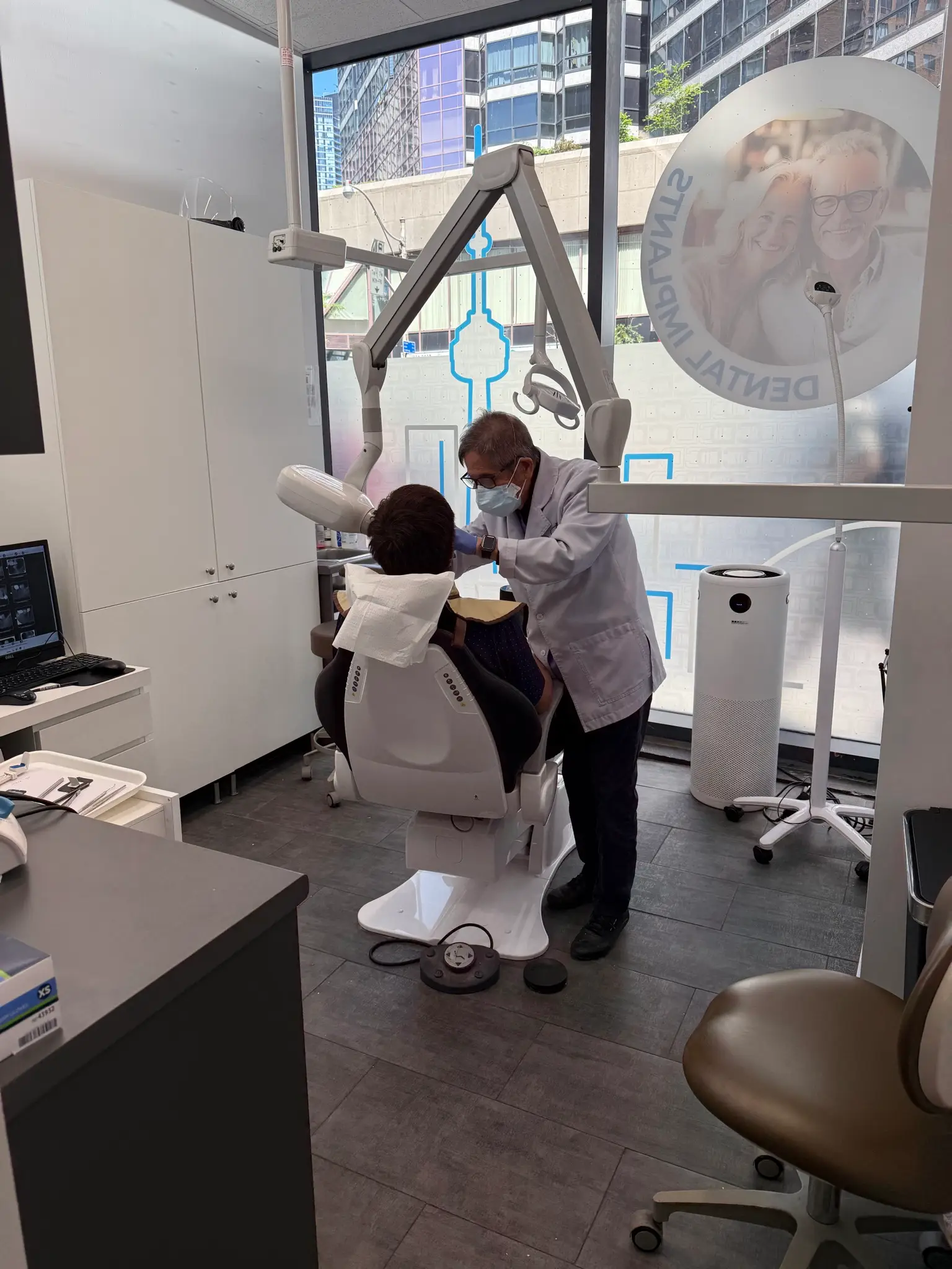 Dr. David Lok treating a patient in the operatory at Lok Dentistry on Bay Street