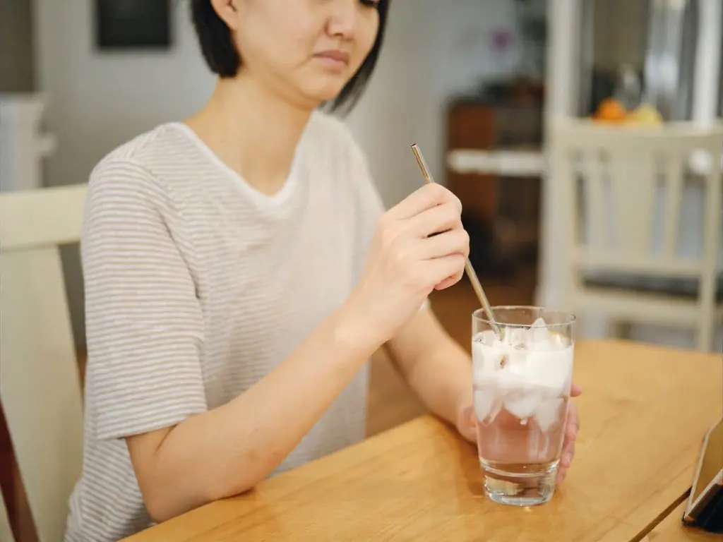 Man reacting to sharp tooth pain from an iced drink