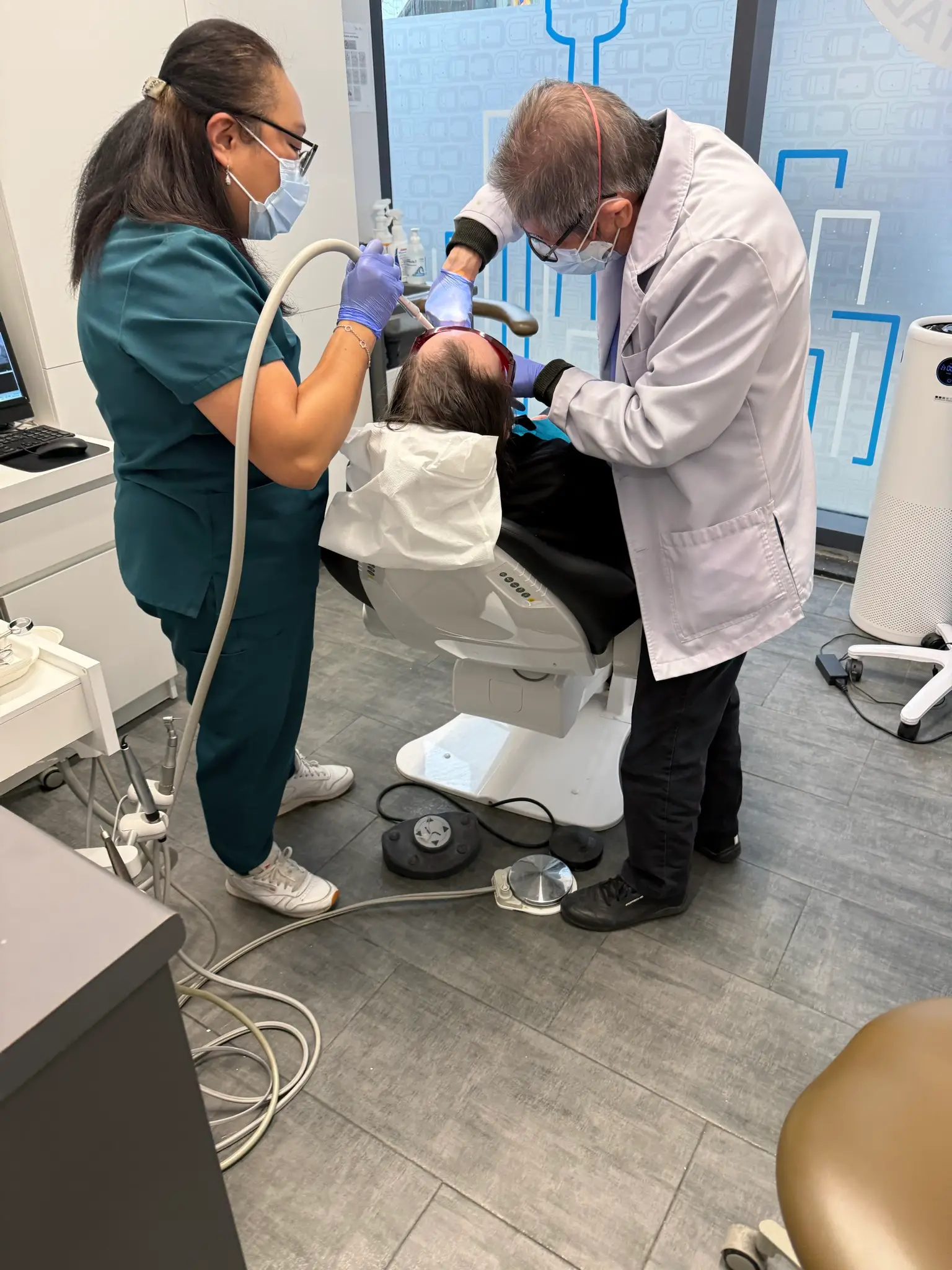 Dr. David Lok and his dental assistant restoring a patient's tooth at Lok Dentistry on Bay Street, Toronto